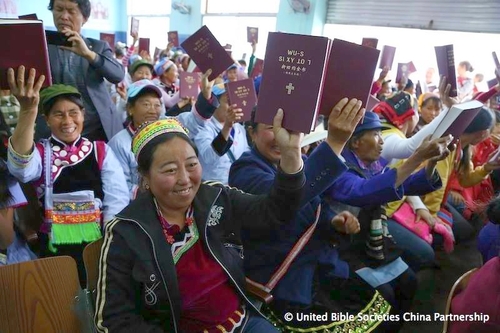 Kuvassa naisia, jotka pitävät käsissään kiinalaisia raamattuja.