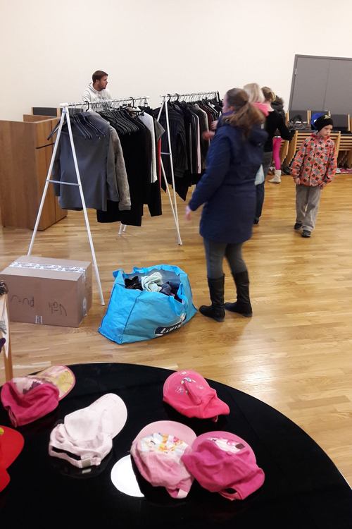 Ihmisiä vaaterekkien luona Yli-Maarian seurakuntatalolla