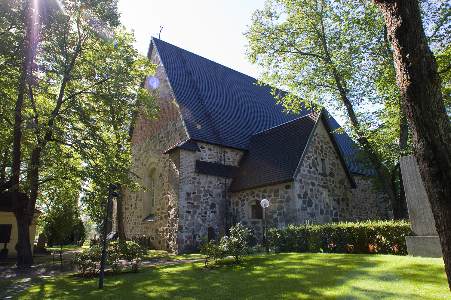 Stone church surrounded by trees. Photo: Timo Jakonen.