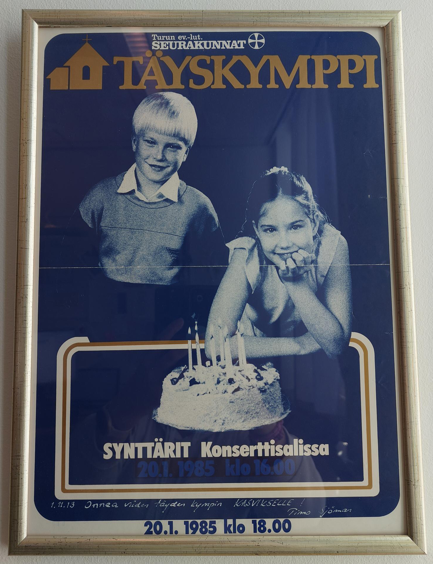 Juliste, jossa on kaksi lasta syntymäpäiväkakun äärellä ja teksti